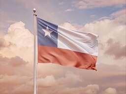 Texas Flag Flying in the Sky with Clouds in the Background