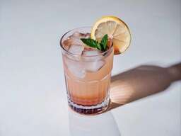 Glass Filled with a Drink Sitting on Top of a Table