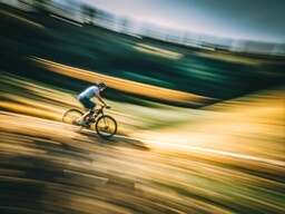 A Blurry Photo Of A Person Riding A Bike