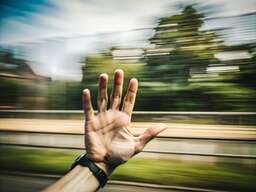 Person ' S Hand in the Middle of a Train