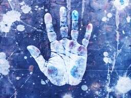 person's hand with paint all over it
