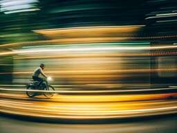 Person Riding a Bike on a City Street