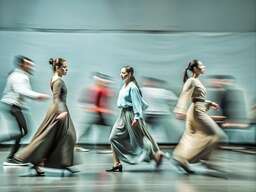 Group of People Walking in a Large Room