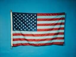 American Flag Hanging on a Blue Wall