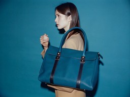 파란색 bag 안의 앞 파란색 wall을 들고 있는 여성