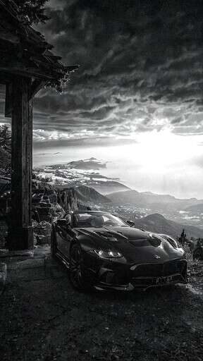 A Sports Car Parked In Front Of A Cabin
