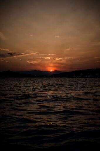 A Sunset Over A Body Of Water 3