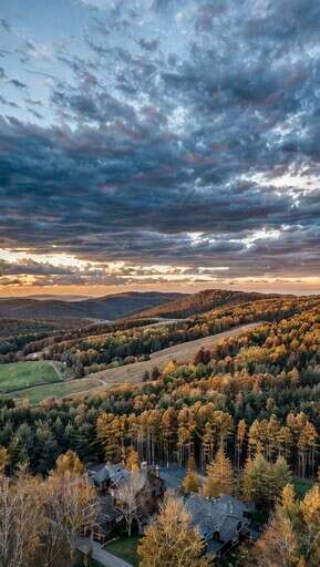 An Aerial View Of A Wooded Area At Sunset