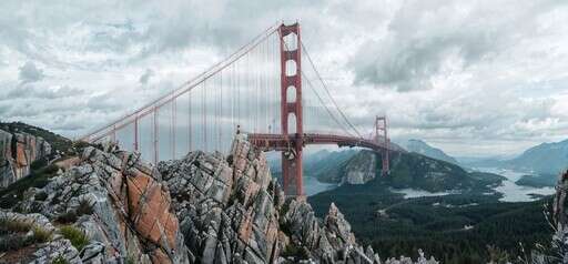 an Image of a View of the Golden Gate Bridge From the Top of a Mountain