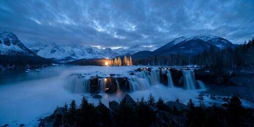 a Waterfall in the Middle of a Lake with Snow on the Ground