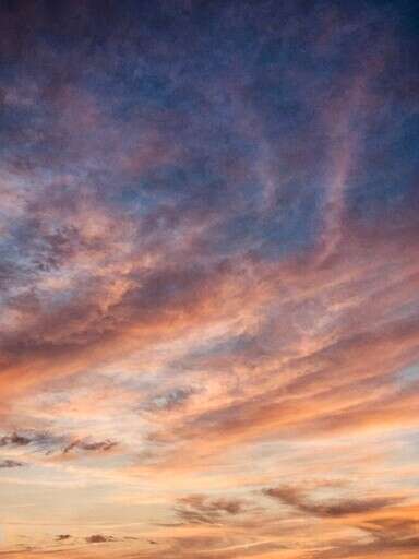 a Plane That Is Flying in the Sky at Sunset 2