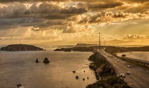 a large body of water that is next to a bridge
