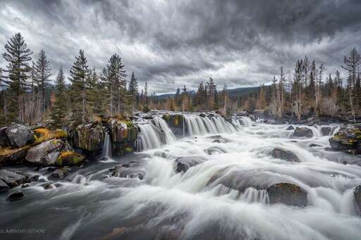 a large waterfall that is flowing down the side of a mountain 2