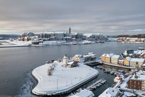 A Winter Scene Of A Harbor With Snow On The Ground