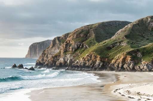 large sandy beach with white wavy water