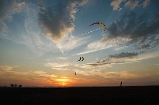 kite flying during sunset
