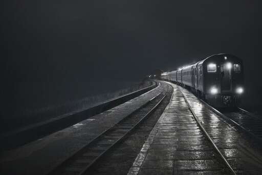 black and white photo of a train on tracks