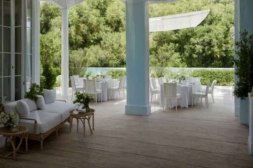 covered porch with tables and chairs