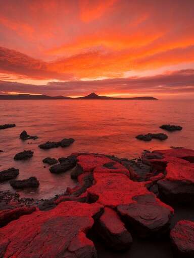 sunset over the ocean with rocks in foreground 14