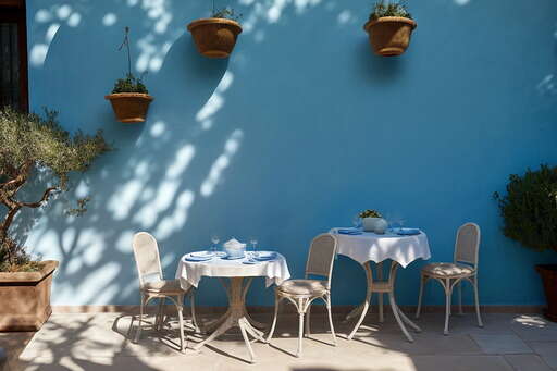 A Table And Chairs In Front Of A Blue Wall