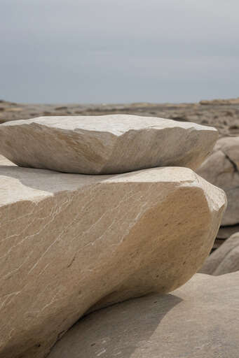 Rocks Stacked On Top Of Each Other On A Rocky Beach